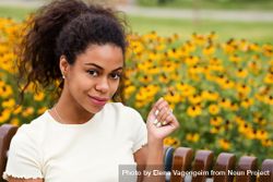 Black Female Sitting On Bench In Front Of Flowers Free Photo Mz A