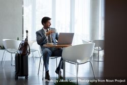 Businessman Sitting In Airport Waiting Area Free Photo 48BaNv