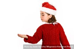 Female child in Christmas outfit with hand up to copy space 0LyvR5