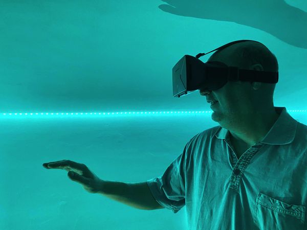 Side view of man wearing virtual reality headset indoor