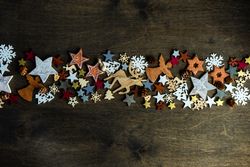 Top view of flat cut out Christmas ornaments in center of table
