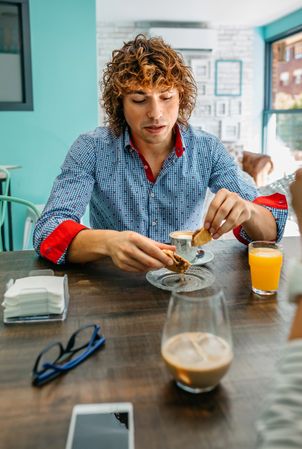 Young man eating breakfast