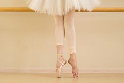 Ballet dancer with one foot in pointe shoes