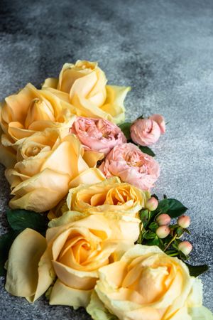 Beautiful floral card concept with fresh roses on grey counter