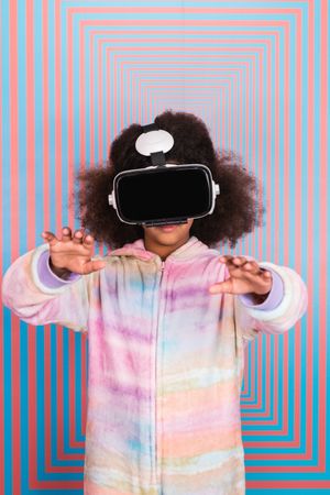 Black girl using VR goggles in studio