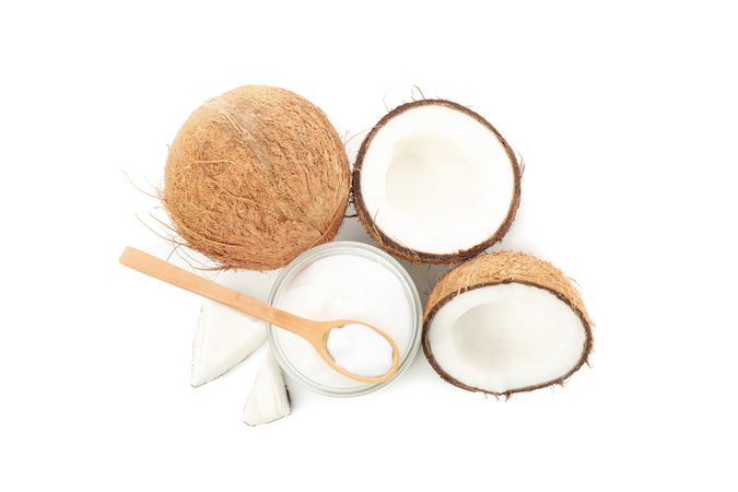 Coconut and cosmetic isolated on plain background. Tropical fruit