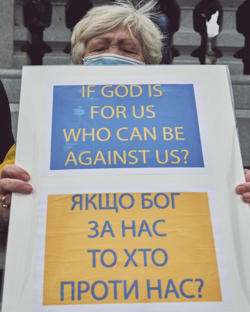London, England, United Kingdom - March 5 2022: Woman with anti-war sign in English & Cyrillic