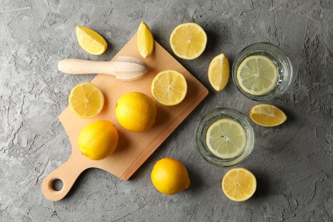 Composition with lemonade and lemons on gray background