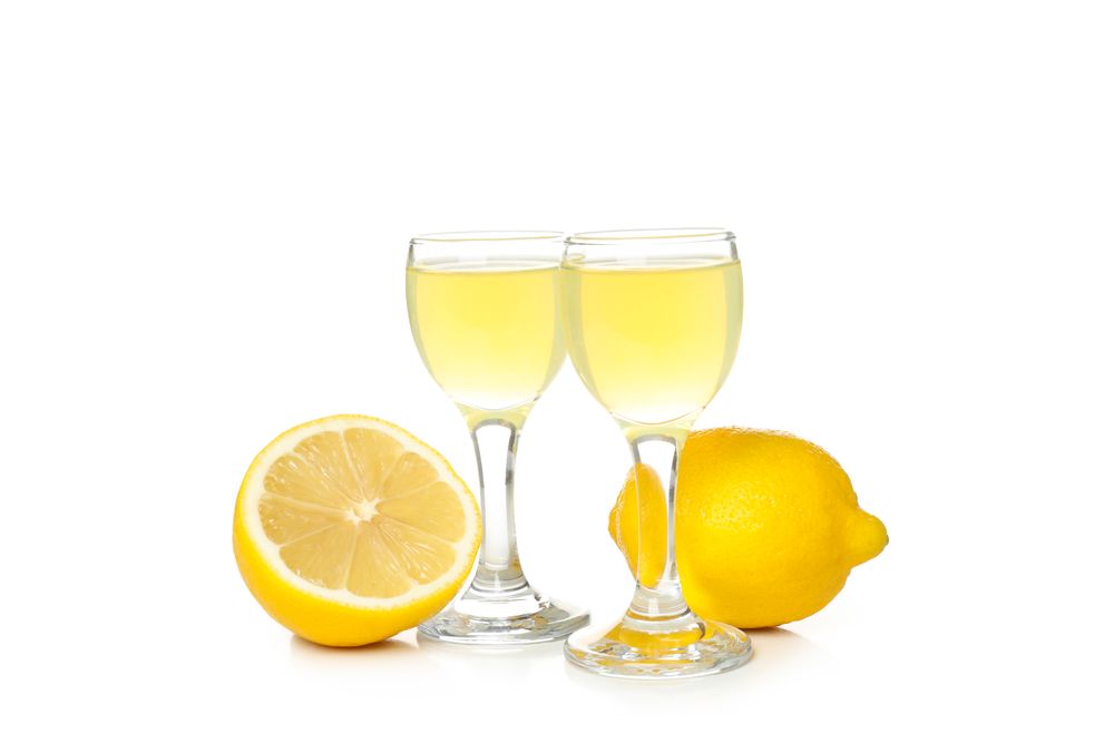 Limoncello, Italian lemon liqueur, isolated on light background