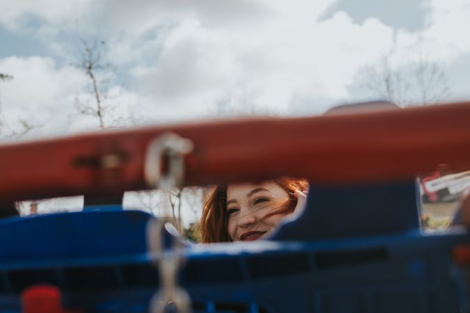 Woman looking through trolley grate in shopping cart