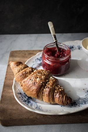 Served breakfast meal with croissant and jam