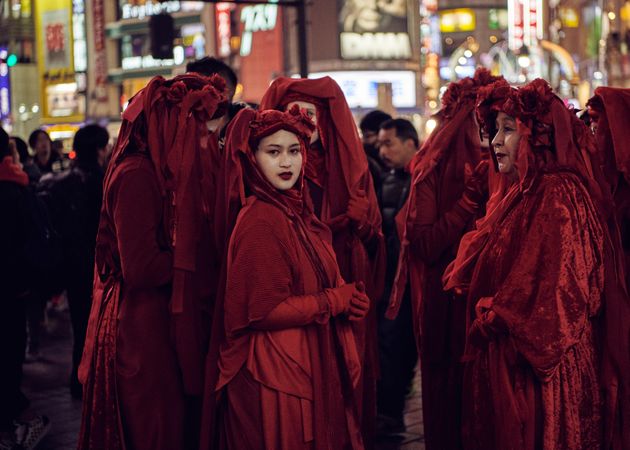 Japan - Tokyo, Shibuya Japan - November 29th, 2019: Woman in Red Rebel Brigade looking back