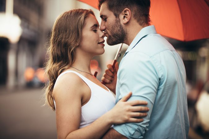 Couple standing on street embracing  each other