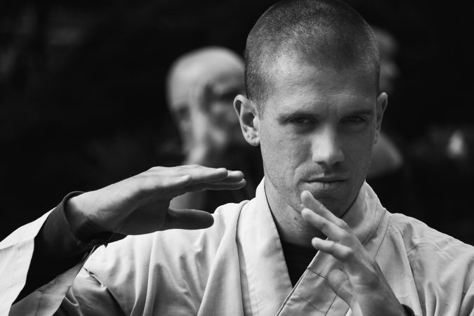 Bald man practicing martial arts in garden