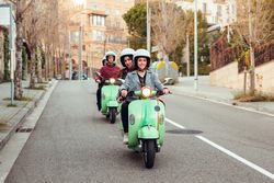 Young people riding motorcycles on city road