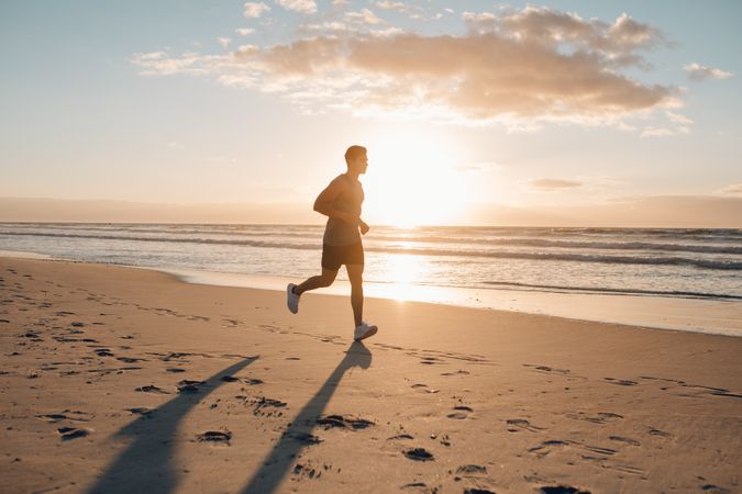 Runner running in morning along the beach