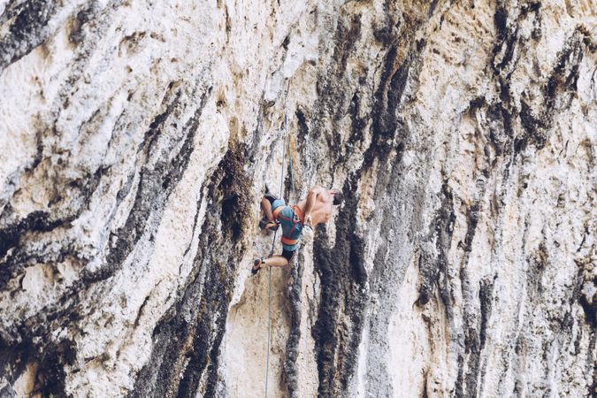 Anonymous man climbing rock
