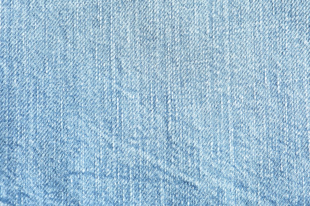 Texture of blue jeans as background, space for text