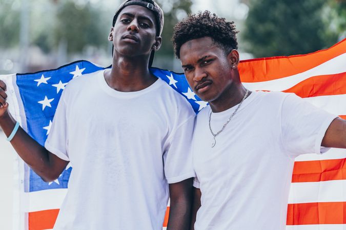 Black men in American Flag outside