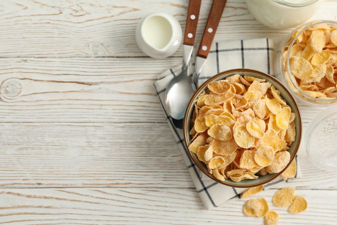 Concept of breakfast with muesli and milk on wooden table