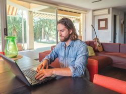 Focused man using computer in apartment