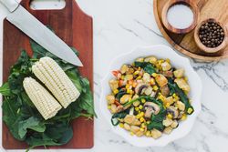 Served chicken with mushrooms corn and greenery