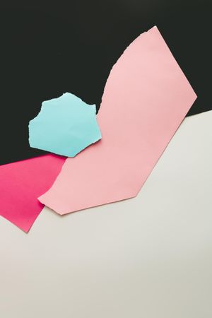 Flat lay of ripped pastel colored paper, top view with copy space