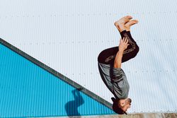 Trendy male flipping on street