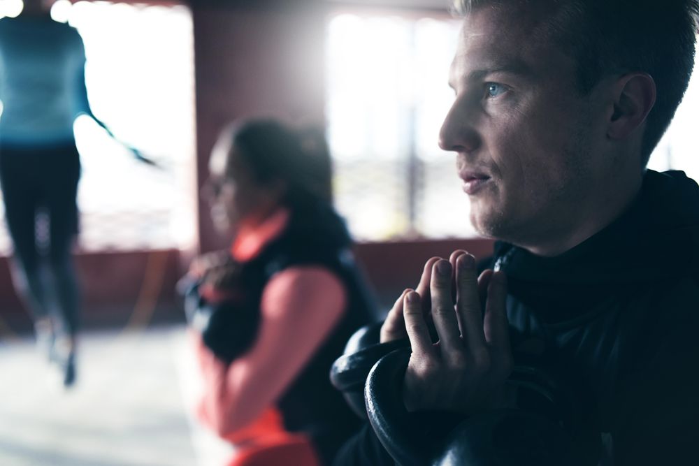 Close up of man’s face as he works out with a kettle bell