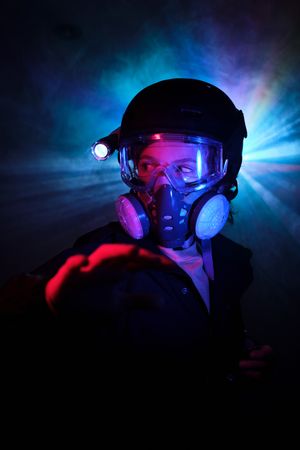 Boy in respirator observing dark mint during robbery
