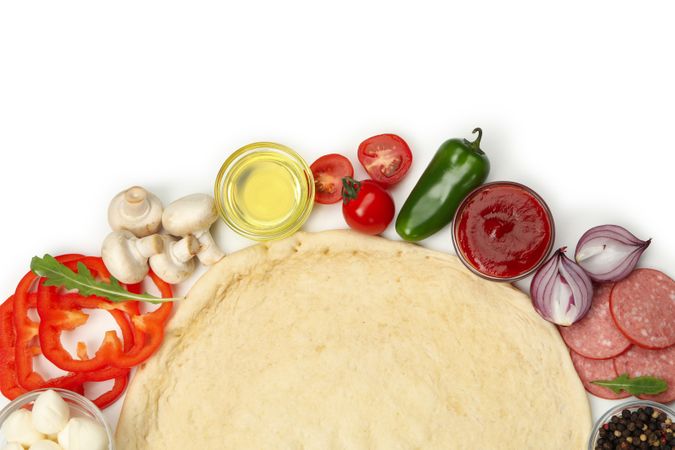 Dough and ingredients for cooking pizza isolated on blank background