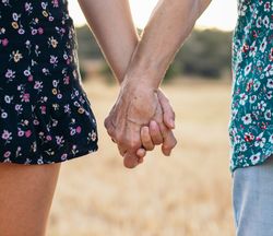 Two Generations Of Women Hold Hands: Grandmother And Granddaughter Holding Hands