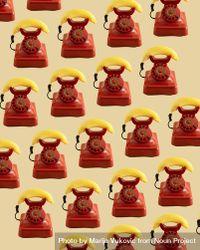 Rows of a vintage red telephone with banana as ear piece 4BoDeb