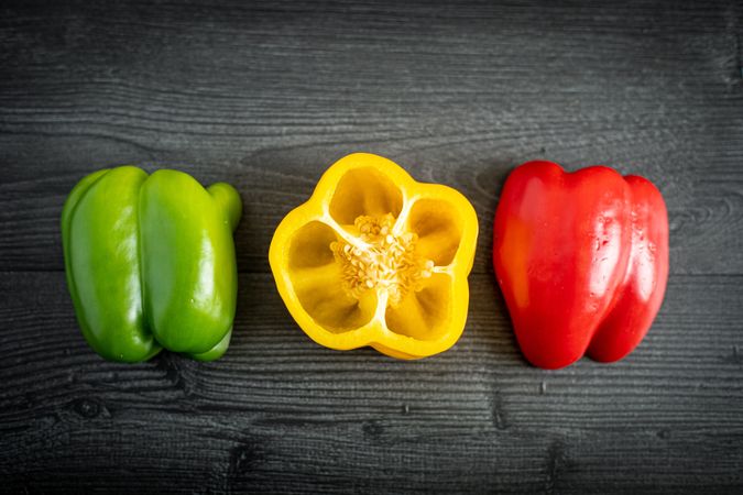 Ripe shiny sliced peppers on gray surface