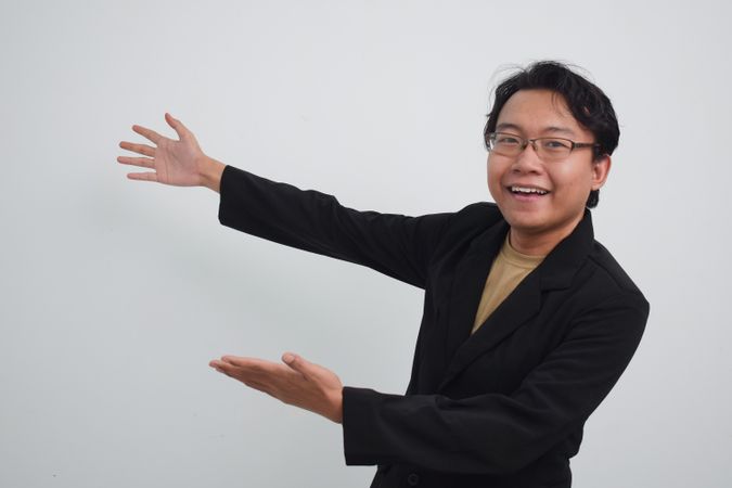 Asian Businessman gesturing to his side