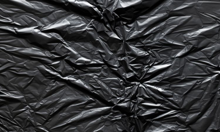 dark crumpled and creased plastic poster texture background