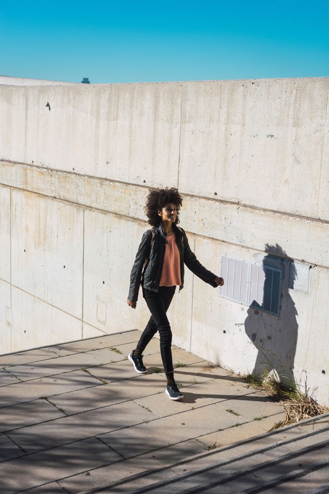 Black woman walking down the street.