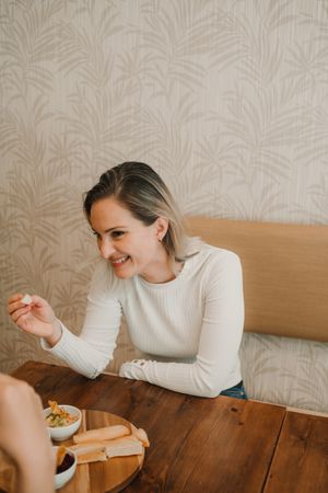 Woman smiling choosing food at table