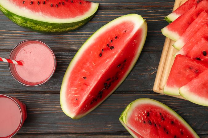 Composition with watermelon slices and juice on wooden background. Summer fruit