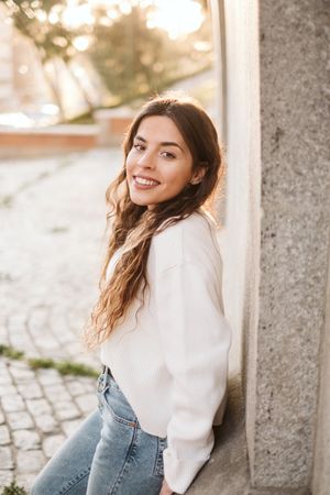 Cheerful young woman in street