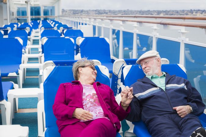 Mature Couple Relaxing On The Deck Of Cruise Ship