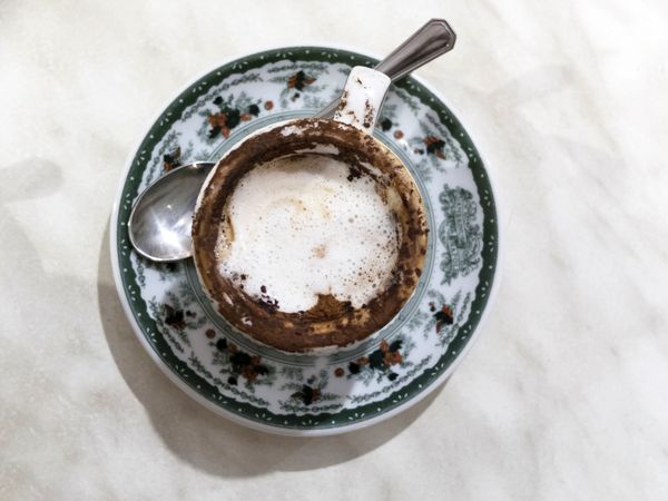 Top view of cappuccino cup isolated on marble background