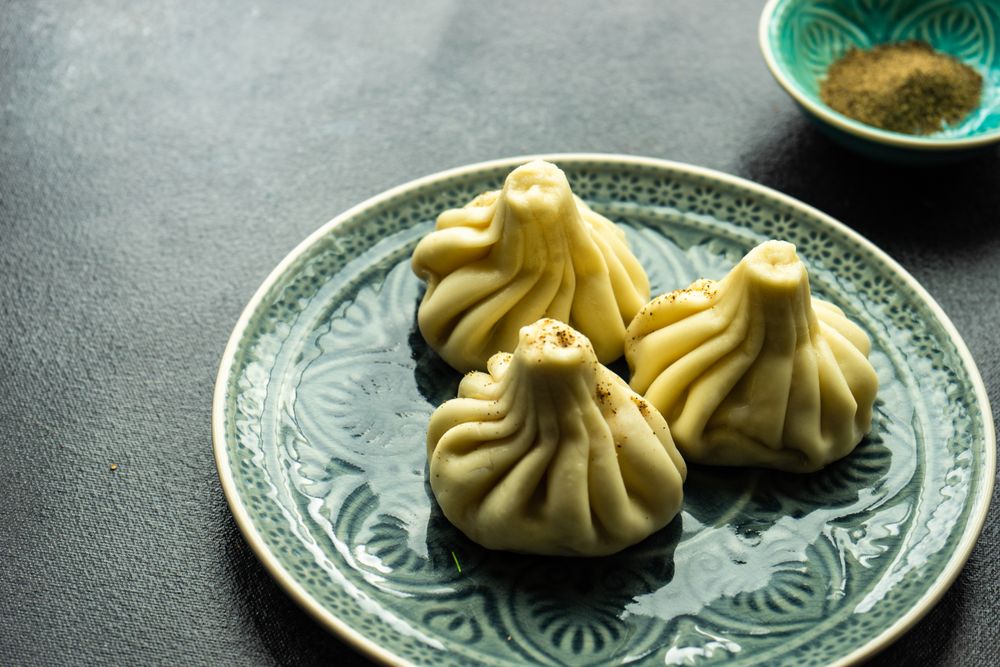 Patterned plate with three Georgian khinkali dumplings