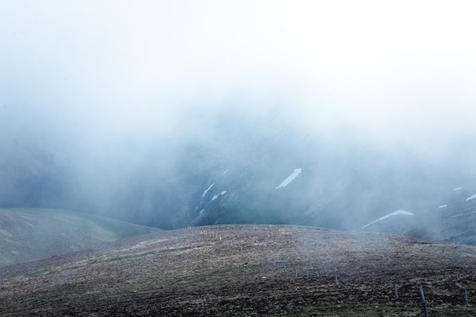 Fog over asphalt mountain road