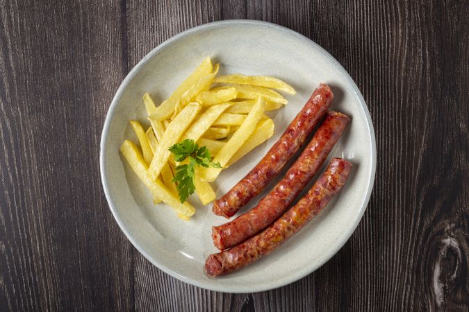 Grilled German sausage with french fries.