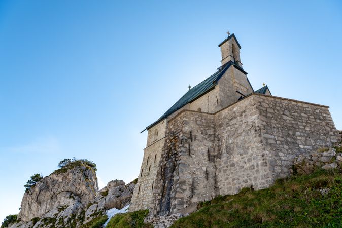Stone church on a mountaintop in the Bavarian Alps on a sunny day in summer