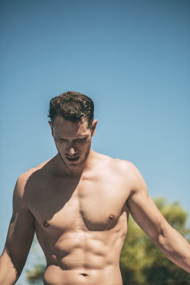Handsome muscular man in sunny day