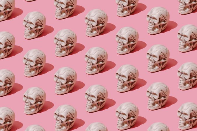 Row of skulls on pink background