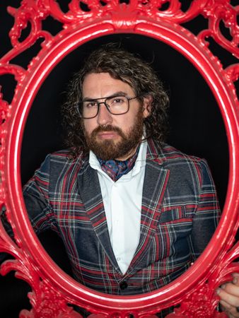Portrait of imposing man in red art frame