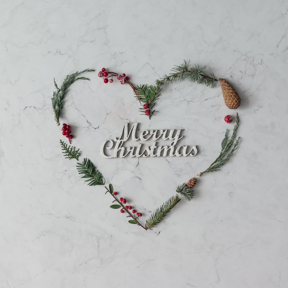 Heart shape made of winter foliage with the words “Merry Christmas”